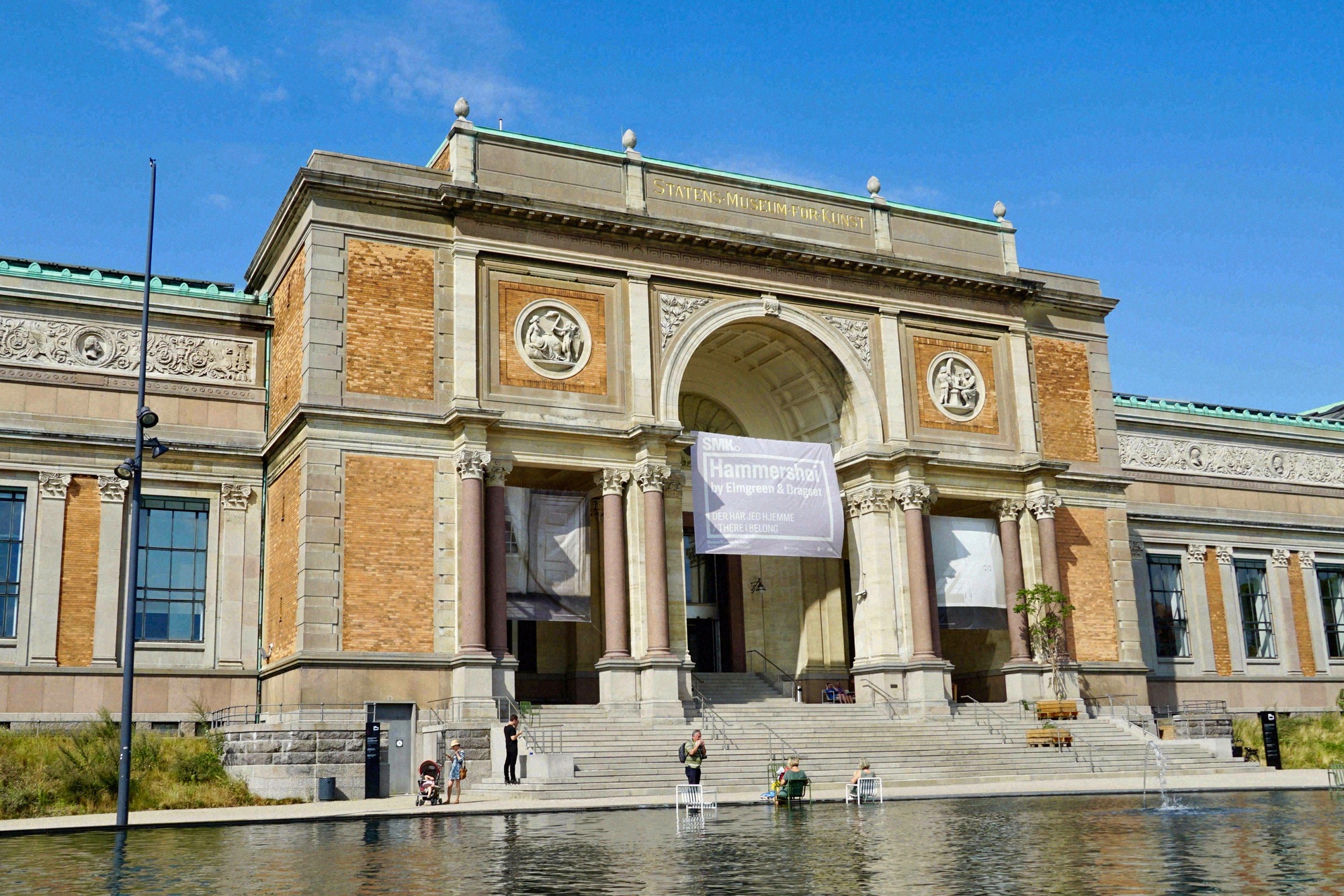 The neoclassical facade of the Statens Museum for Kunst (SMK) with a Hammershøi exhibition banner above the entrance.