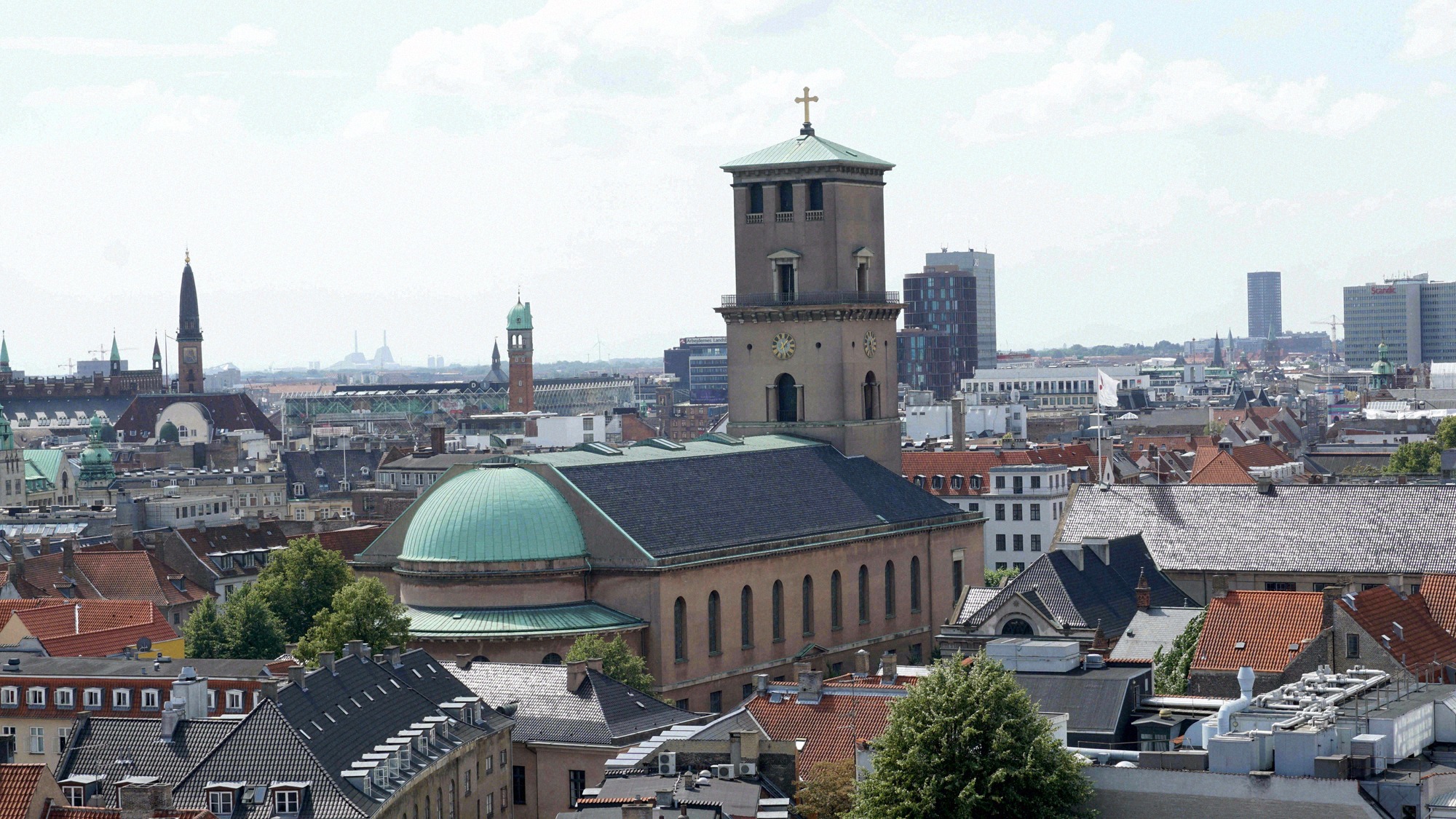 City panorama from the Round Tower: in the foreground the neoclassical Vor Frue Kirke (Copenhagen Cathedral) with its green dome and square bell tower.